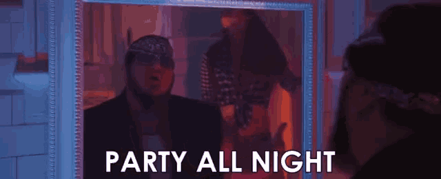 a man is standing in front of a mirror with the words party all night written on it .