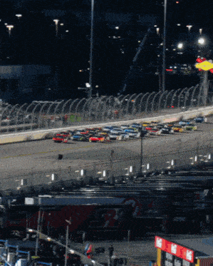 a race track with cars on it and a coca cola sign