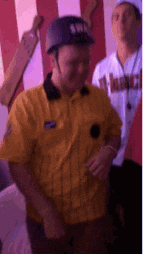 a man in a yellow shirt is wearing a black helmet with the word swp on it