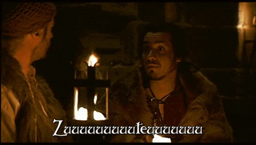 two men are standing next to each other in a dark room with a candle in the background and a caption that says zuuuuuuuuu