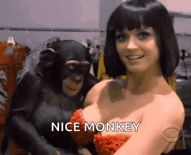 a woman is holding a chimpanzee in her arms with the words nice monkey below her