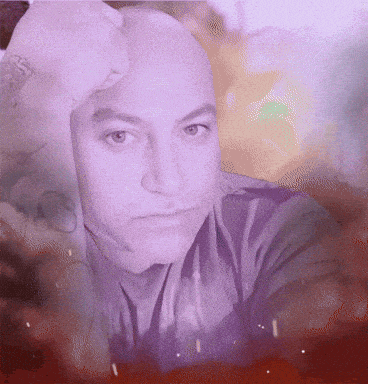 a close up of a man 's face with a hand on his forehead