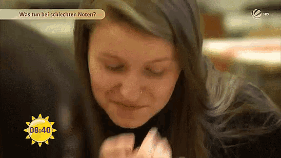 a woman eating a piece of food in front of a sun that says 8:40