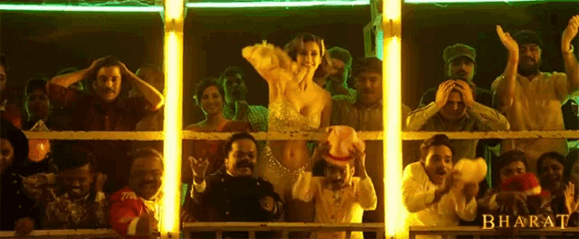 a group of people are watching a show and the word bharat is on the bottom