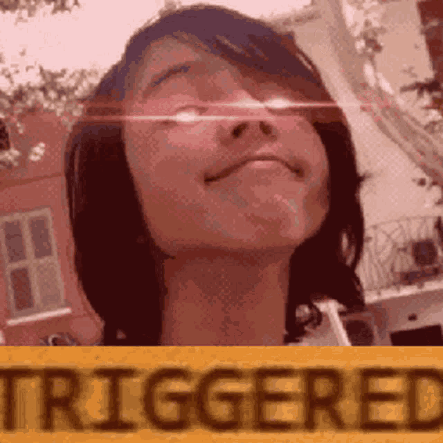 a girl is standing in front of a sign that says triggered .