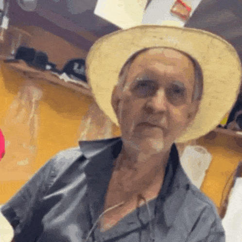 an older man wearing a straw hat and glasses