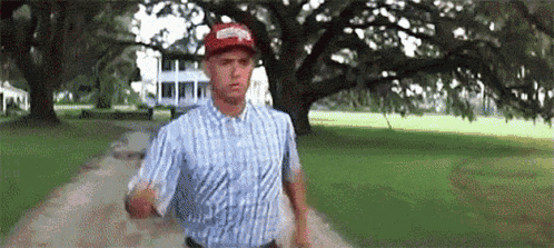 forrest gump is running down a dirt road in a park .