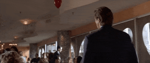 a man in a suit and tie stands in front of a sign that says i have to go