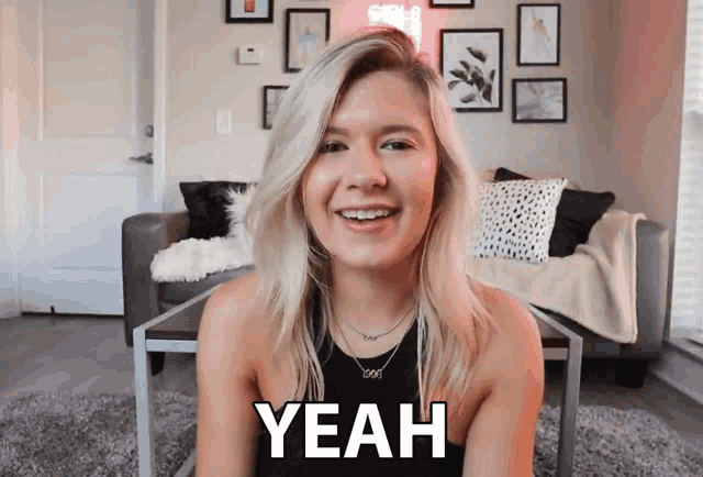 a blonde woman is smiling and says yeah