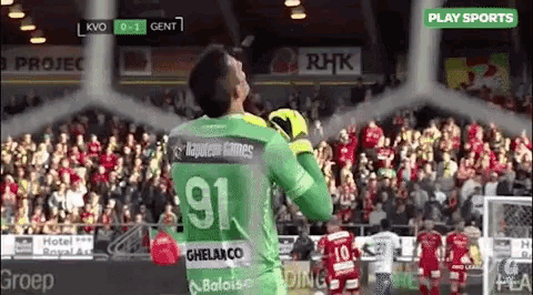 a soccer player wearing a green jersey with the number 91 on the back