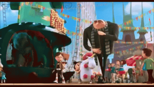 a group of despicable me characters are standing in front of a roller coaster