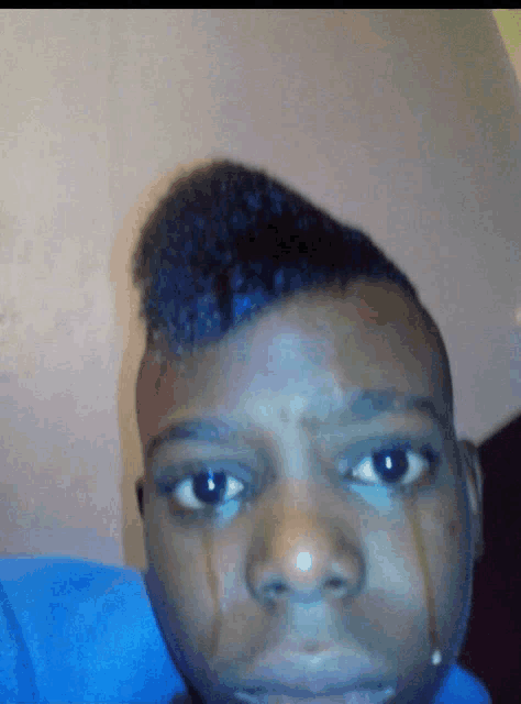 a close up of a person 's face with a tear coming out of his nose