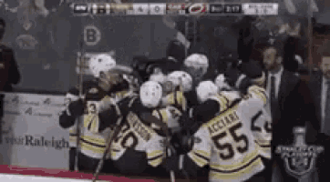 a group of hockey players are huddled together and one of them has the number 55 on his jersey