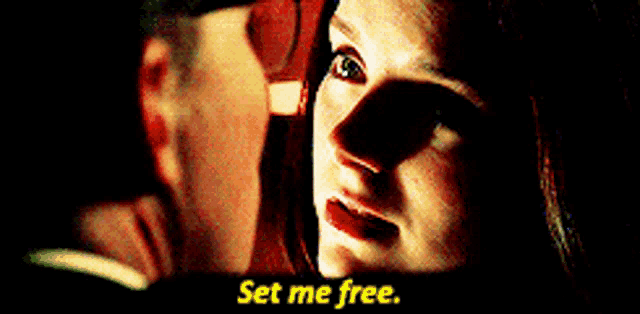 a man and a woman are looking at each other and the woman says " set me free " in yellow letters
