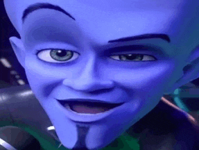 a close up of a blue cartoon character 's face with a beard and green eyes .