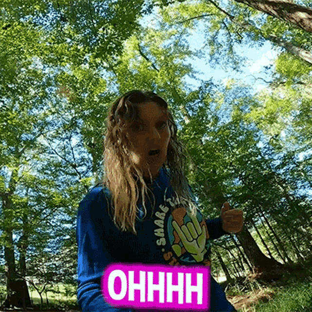 a woman in a blue shirt with the word ohhhh on it