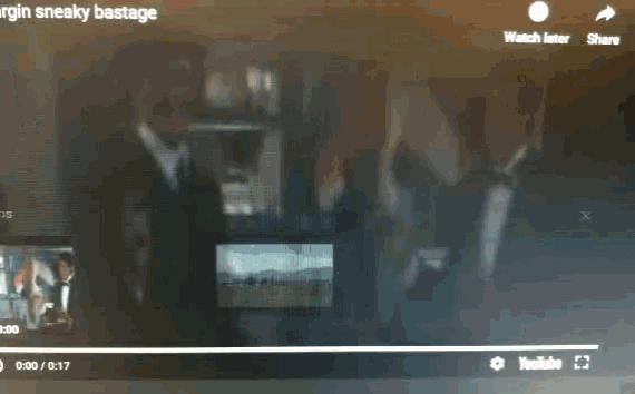 a video of two men in tuxedos is being watched on a computer