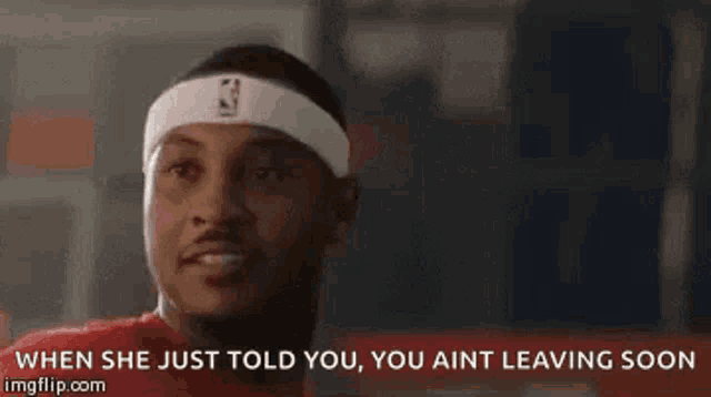 a man wearing a headband that says when she just told you , you ain 't leaving soon