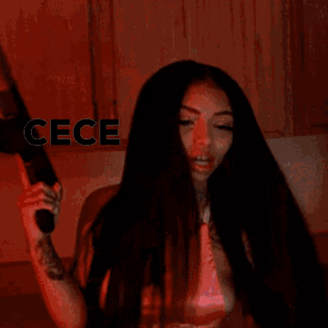 a woman with a tattoo on her arm is giving a thumbs up with the word ccecee above her