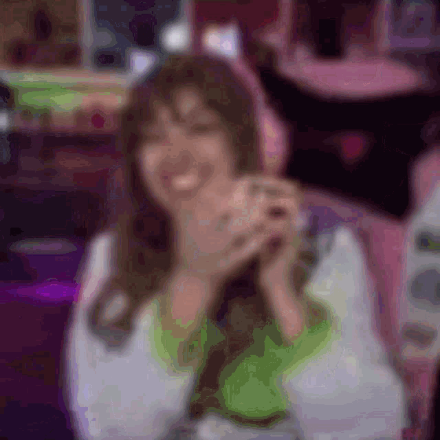 a blurry picture of a woman wearing headphones and a green shirt