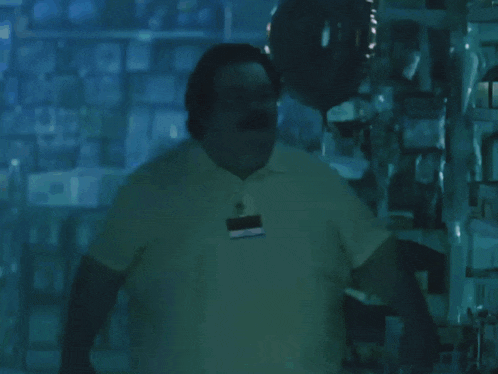 a man in a white shirt stands in a store