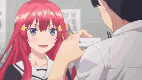 a man giving a card to a girl with red hair and blue eyes
