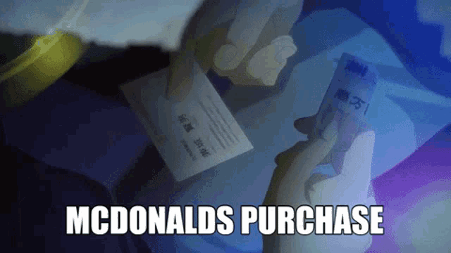 a person is holding a mcdonalds purchase card