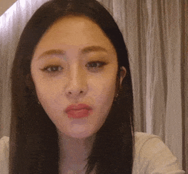 a close up of a woman 's face with a serious look on her face