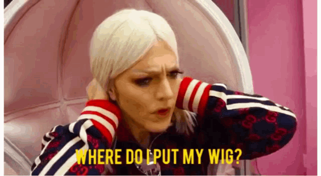 a woman wearing a wig is sitting in a chair and asking where to put her wig .