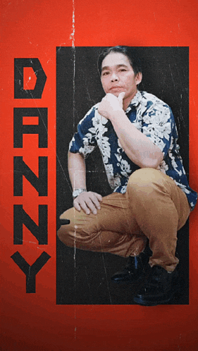 a man in a hawaiian shirt is kneeling down in front of a red background that says ' dizzy ' on it