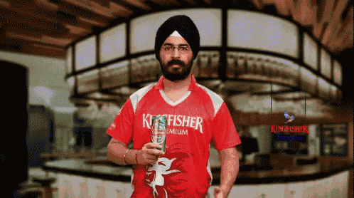 a man wearing a red shirt that says kingfisher on it