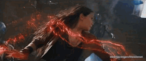 a woman is fighting a robot in a room in a movie scene .