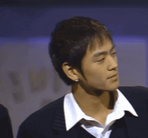 a man wearing a white shirt and a black jacket