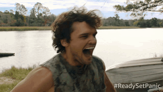 a man is screaming in front of a body of water with the hashtag #readysetpanic