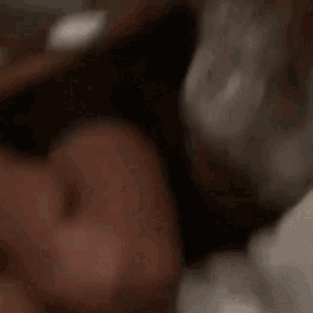 a close up of a person 's face with a blurry background .