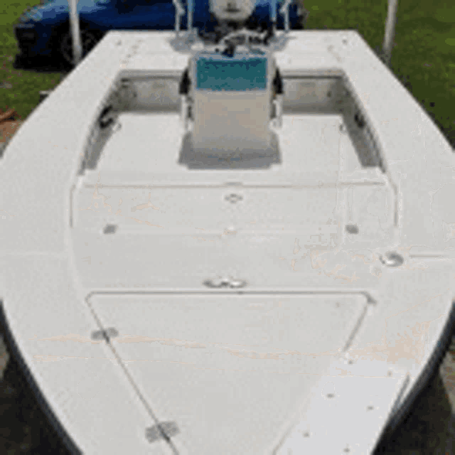 a boat is docked at a dock with a ladder and a motor .