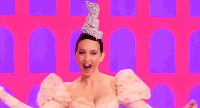 a woman in a pink dress with a crown on her head is screaming
