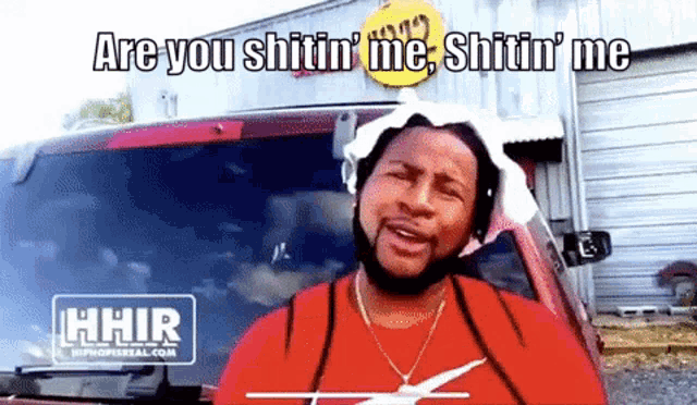 a man in a red shirt says " are you shitin ' me shitin ' me " in front of a red car