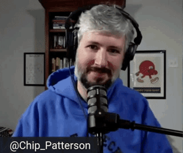 a man wearing headphones stands in front of a microphone with the name chip_patterson written on the bottom