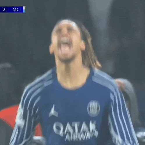 a soccer player wearing a qatar airways jersey celebrates a goal