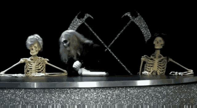 a couple of skeletons sitting at a table with a grim reaper in the background