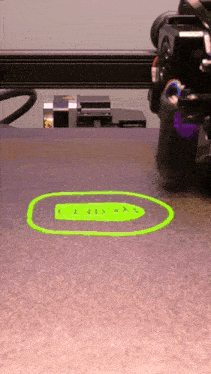 a 3d printer is printing a green object that says u + g = x