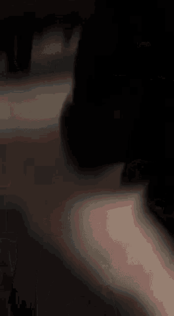 a close up of a person 's feet walking on a dark floor .