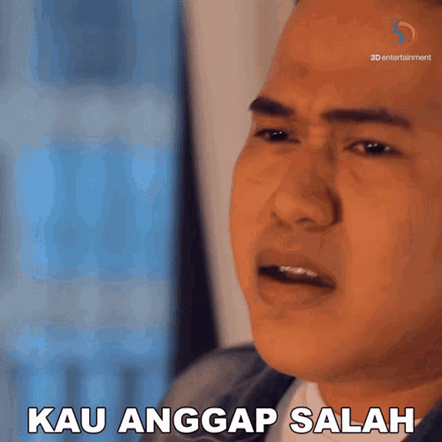 a close up of a man 's face with the words kau angkap salah written below him