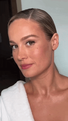 a close up of a woman 's face with a white robe on