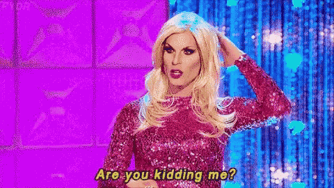 a drag queen is standing in front of a purple curtain and saying `` are you kidding me '' .