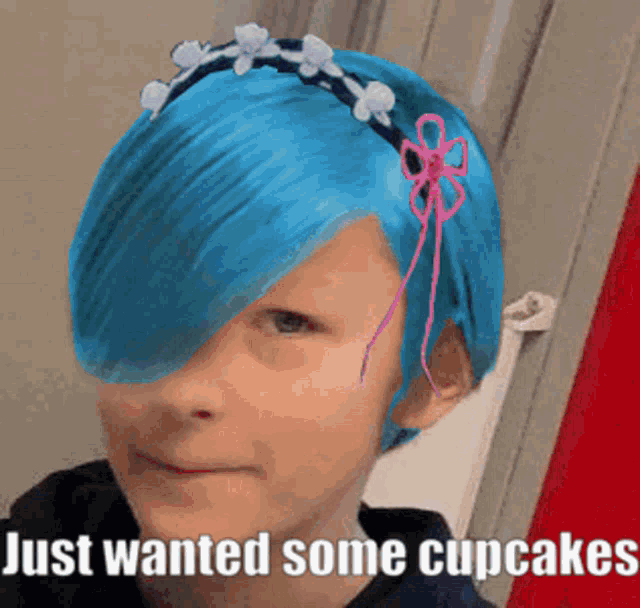 a child with blue hair and a headband with flowers on it says just wanted some cupcakes
