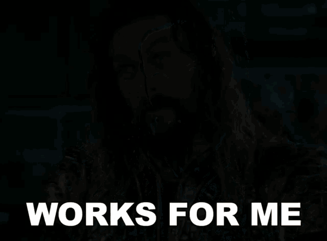 a man with long hair and a beard has the words works for me on his face