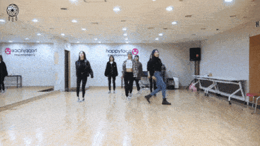 a group of people are dancing in front of a happyface entertainment sign