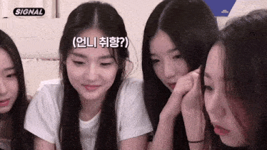 a group of young girls are sitting in front of a sign that says signal on it